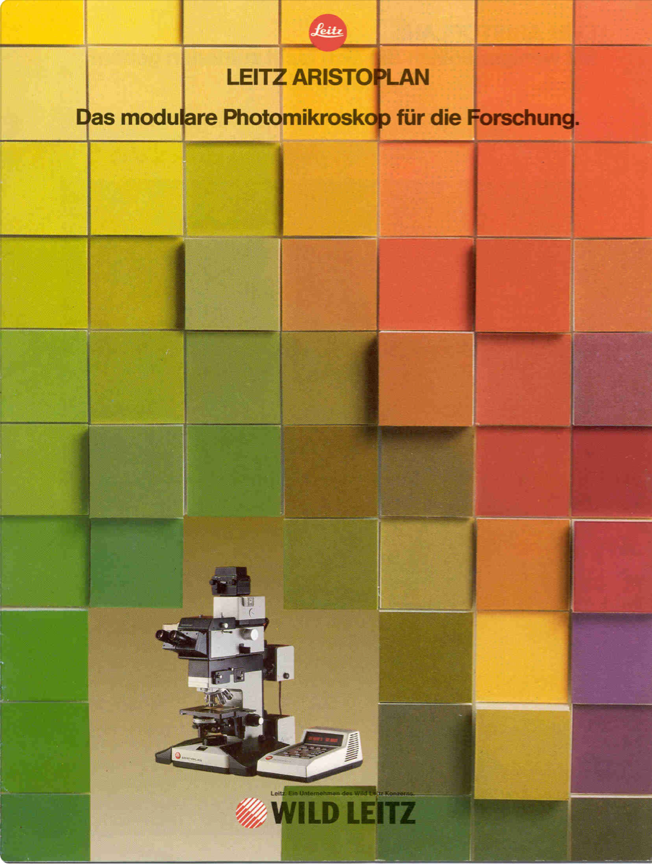 A colorful square boxes with a machine in front of it
Description automatically generated