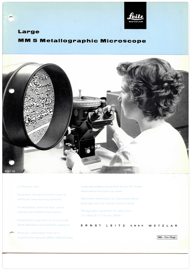 A person looking through a microscope
Description automatically generated