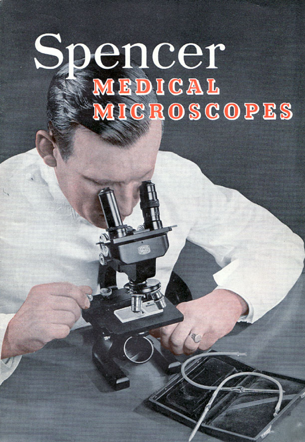 A person looking through a microscope
Description automatically generated