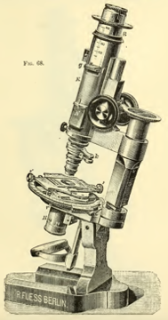 A picture containing object, microscope, sitting, photo
Description automatically generated