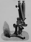 A picture containing sitting, small, table, old
Description automatically generated