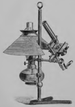 A picture containing indoor, lamp, table, sitting
Description automatically generated