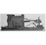 A picture containing sitting, old, table, small
Description automatically generated