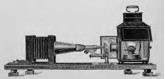 A picture containing indoor, sitting, old, photo
Description automatically generated