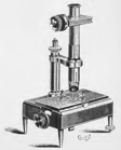 A picture containing old, table, small, sitting
Description automatically generated