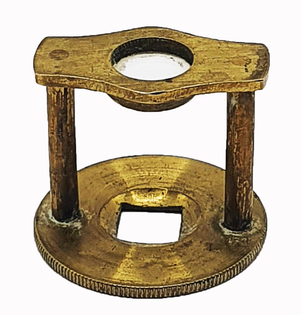 A gold object with holesDescription automatically generated