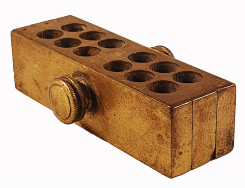 A gold metal box with holes
Description automatically generated